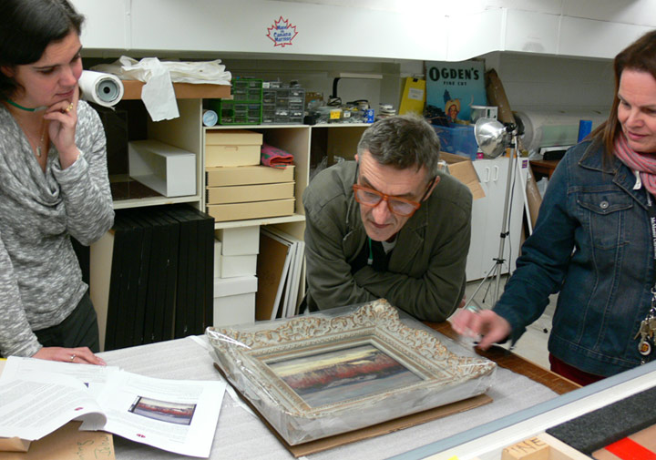 people looking at painting in a lab