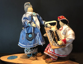 Two stitched doll-like figurines