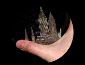 hand holding a model of a building