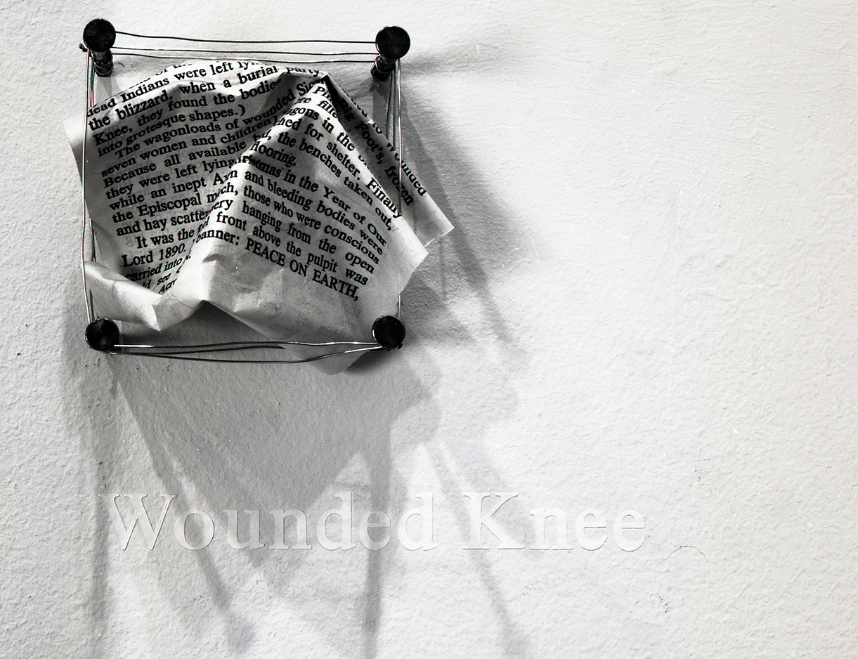 crumpled paper installation above text 