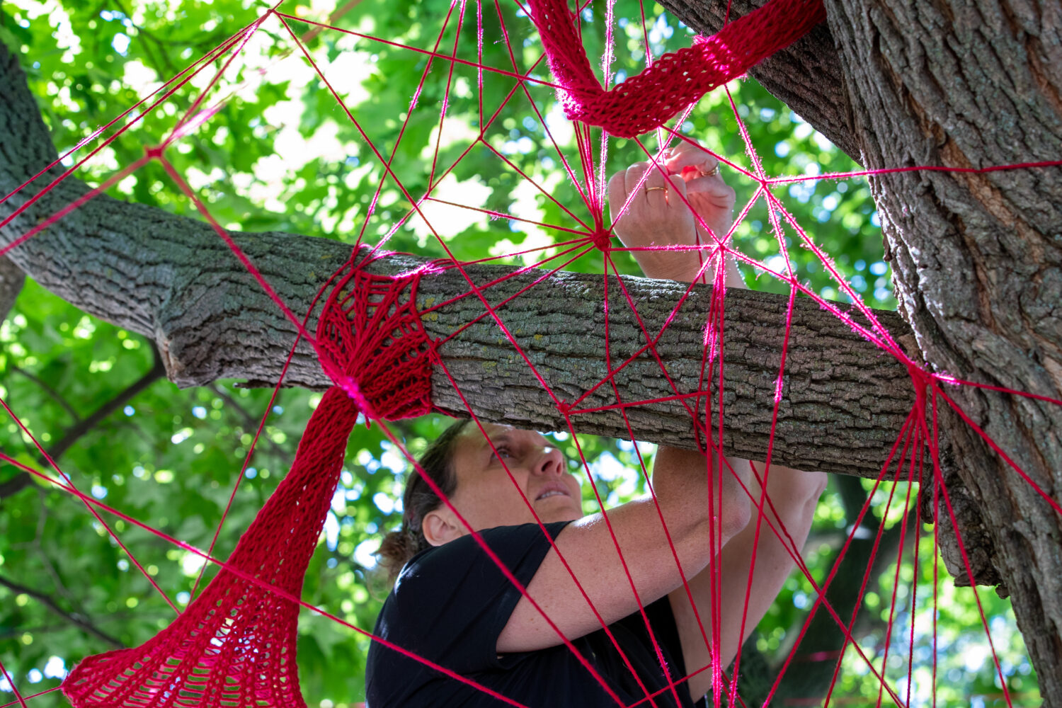 Tracey-Mae chambers installing the red string in a tree