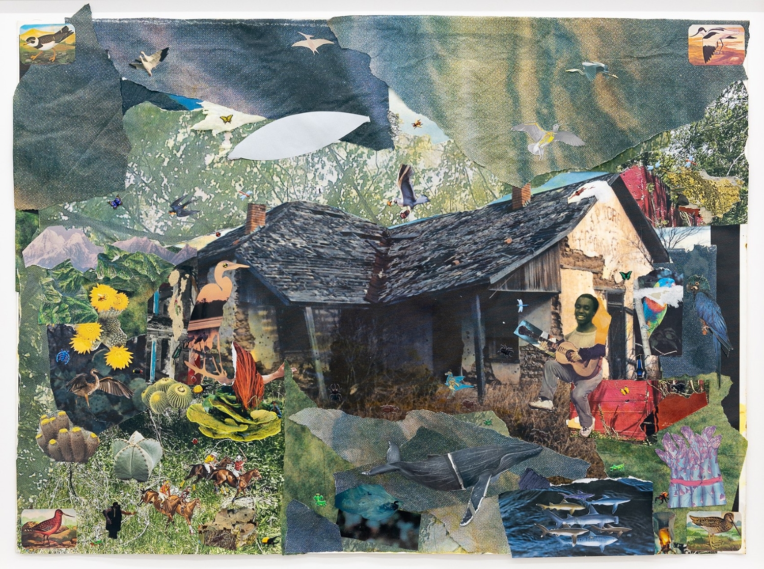 Artwork made out of collaged images on paper featuring a rustic cabin surrounded by flora, fauna, birds, whales, fish and to the right a guitar playing musician.